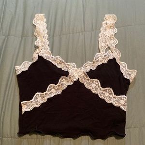 A black tank top with lace straps and lace around the chest!